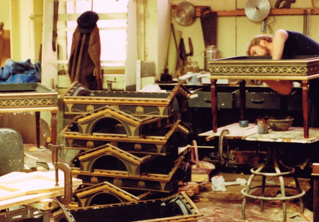 Stacked roofs painted black and gold with intricated flecked details. Roofs have classical structure and embellishments.