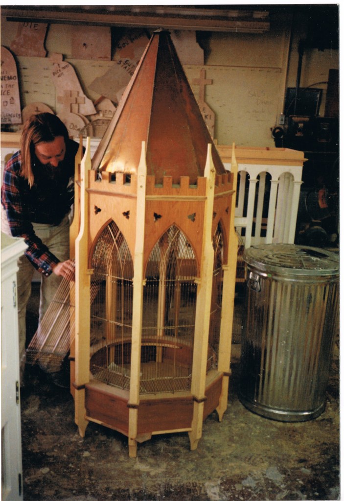 Eric working on castle birdcage, tan with points and metal connections