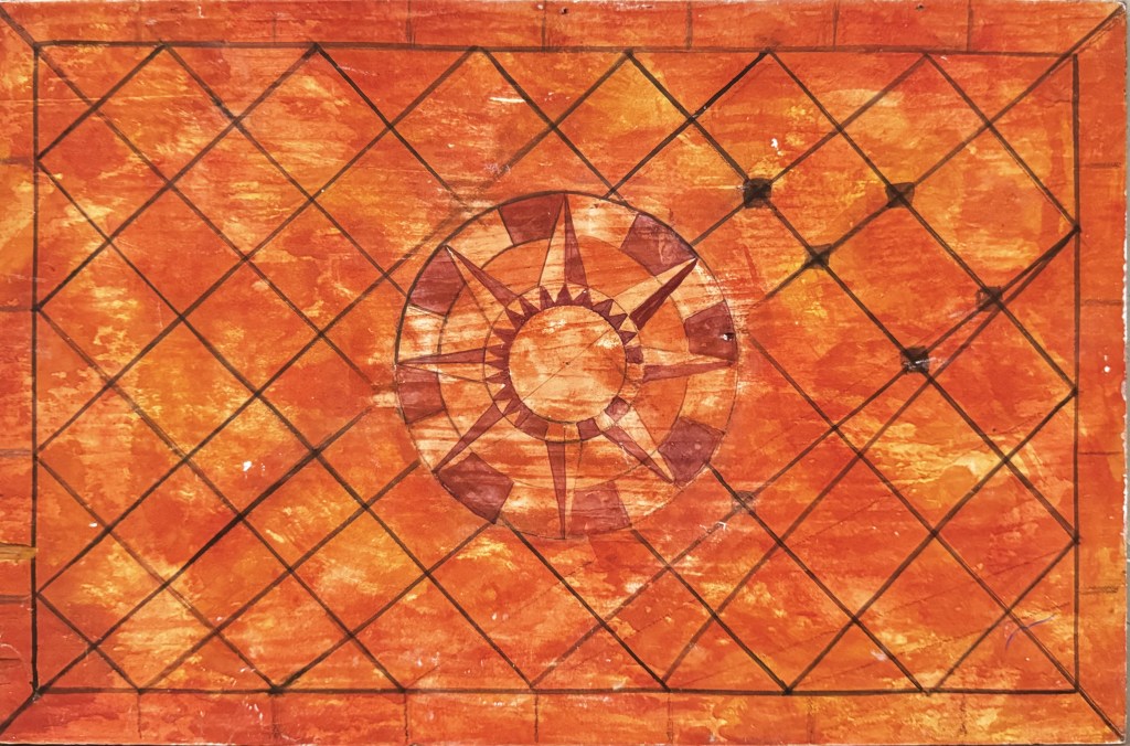 A compass rose design on a tiled orange, hand-painted, roof