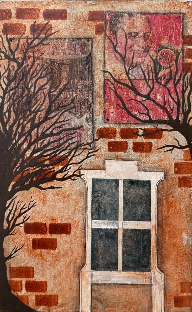 A red brick wall with a white window on the bottom right with 4 panes. Two trees without leaves flank the two sides. In the far background there are two vintage posters fading on the red wall. 